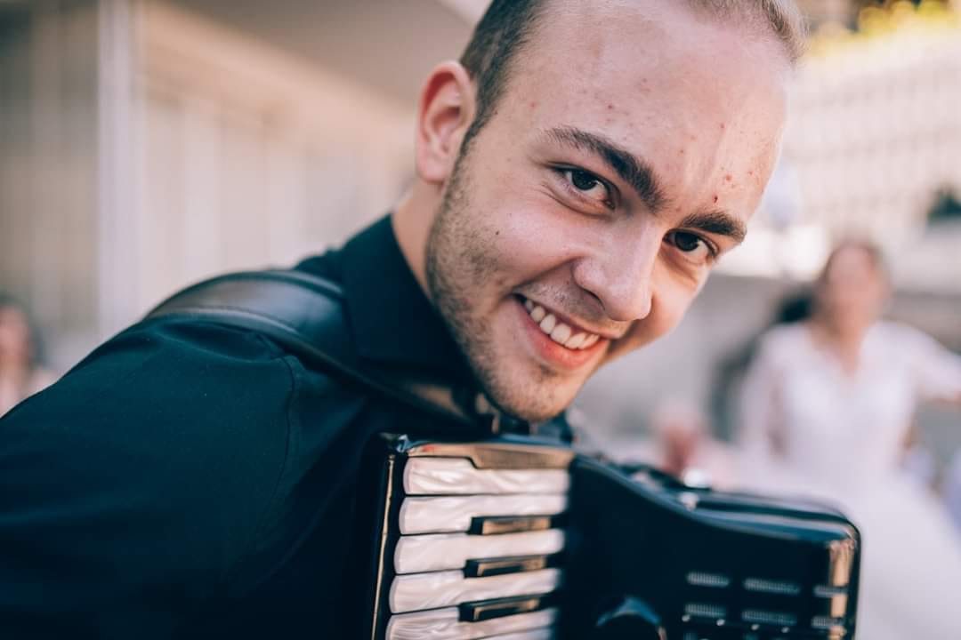 Porträt von Sajdin Horozović mit seinem Konzertakkordeon, lächelnd
